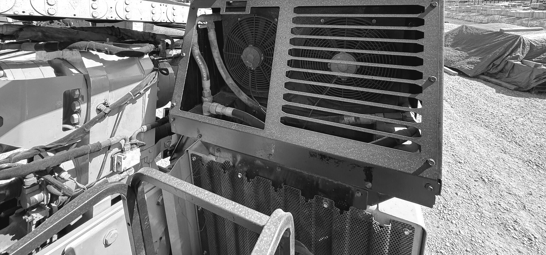 A cooling fan and louvered grille panel on a directional drill's engine enclosure